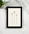 Dried Stems Framed Print, A4 black frame, on marble surface with fern
